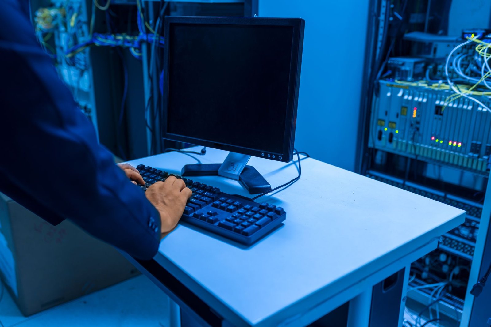 An IT technician operating systems inside a server room